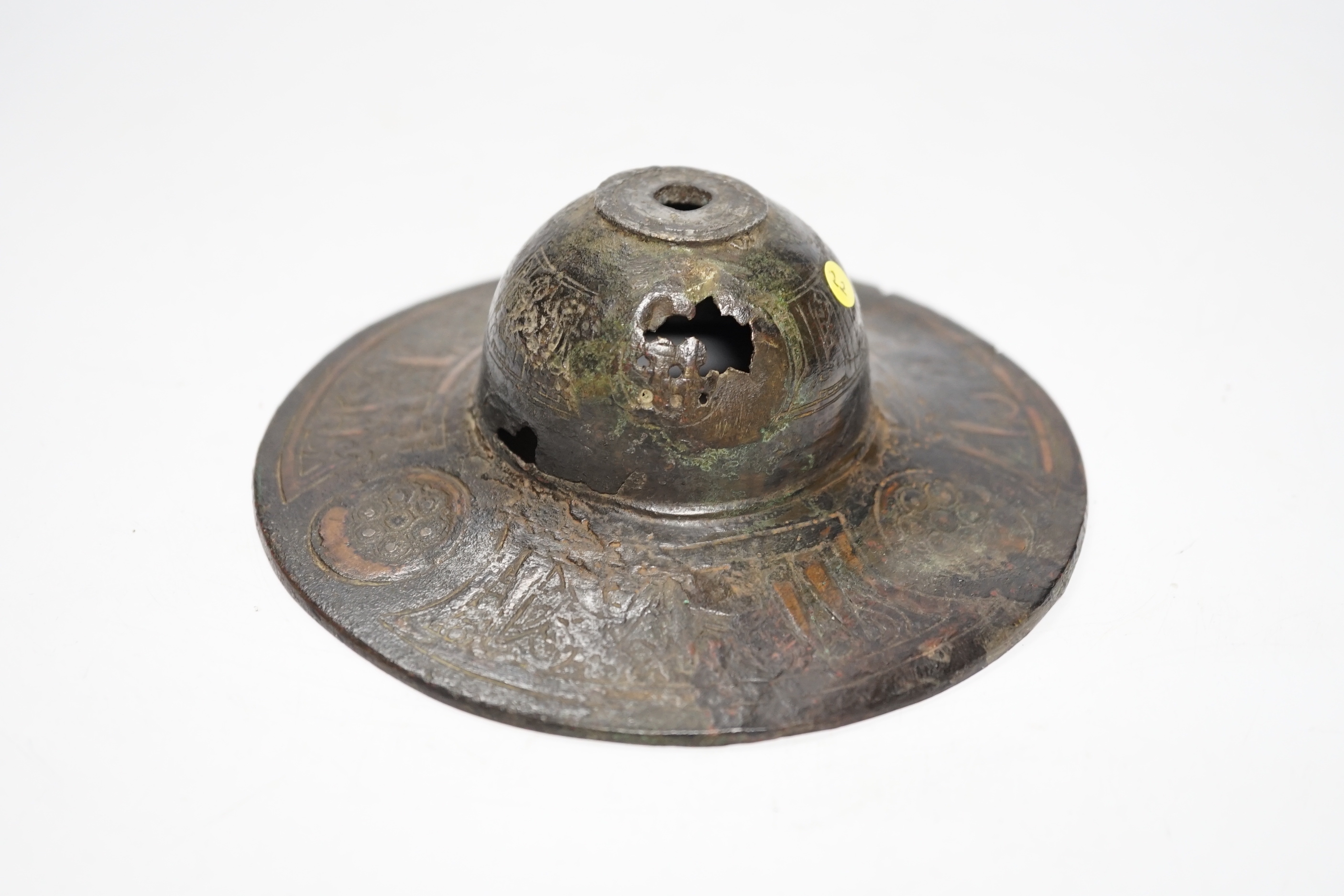 An early Islamic bronze and copper inlaid shield or door boss, probably 12th/13th century, 14.5cm